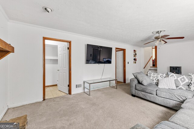 carpeted living room featuring crown molding, a textured ceiling, and ceiling fan