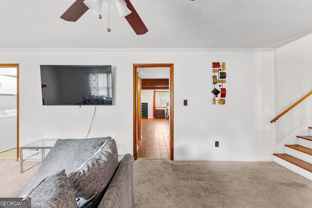 bedroom featuring washer / clothes dryer, ceiling fan, a textured ceiling, carpet floors, and crown molding