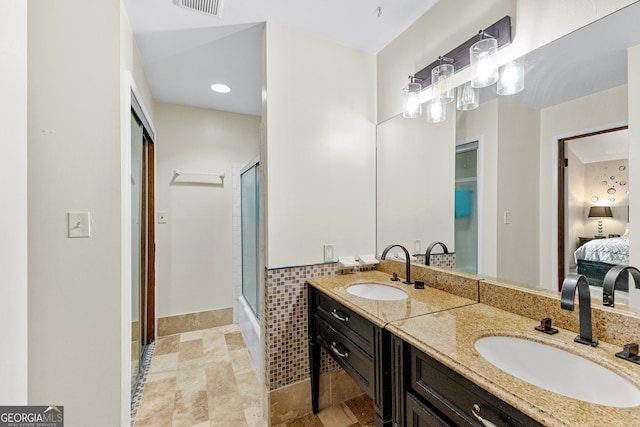 bathroom with vanity and a shower with shower door