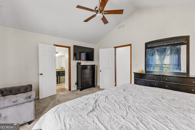 bedroom featuring ensuite bathroom, light colored carpet, high vaulted ceiling, and ceiling fan