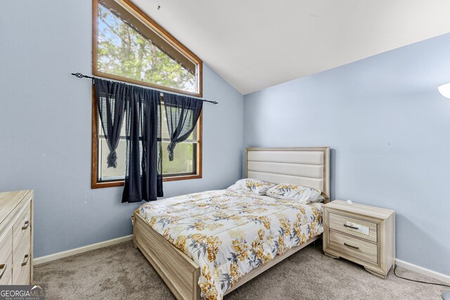 bedroom featuring vaulted ceiling and light colored carpet