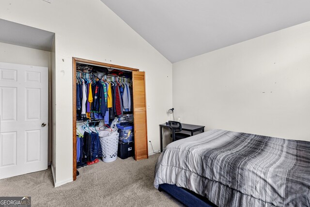 bedroom featuring a closet, carpet, and vaulted ceiling