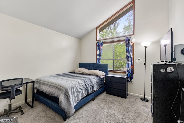 carpeted bedroom featuring high vaulted ceiling