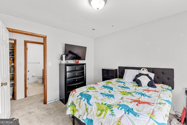 carpeted bedroom featuring ensuite bathroom