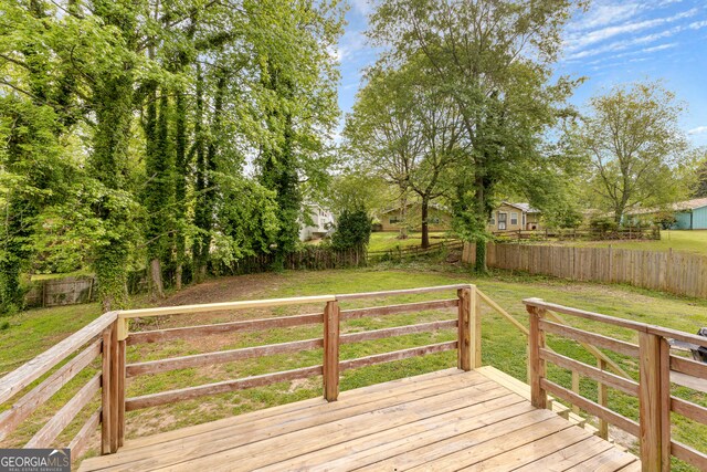 wooden deck with a lawn