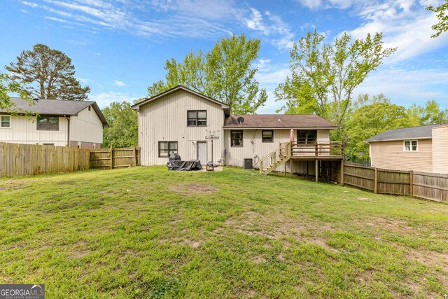 back of house with a lawn and central AC unit