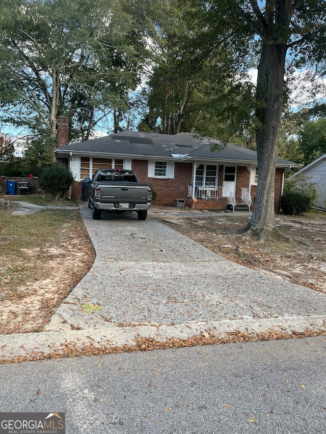 single story home featuring covered porch