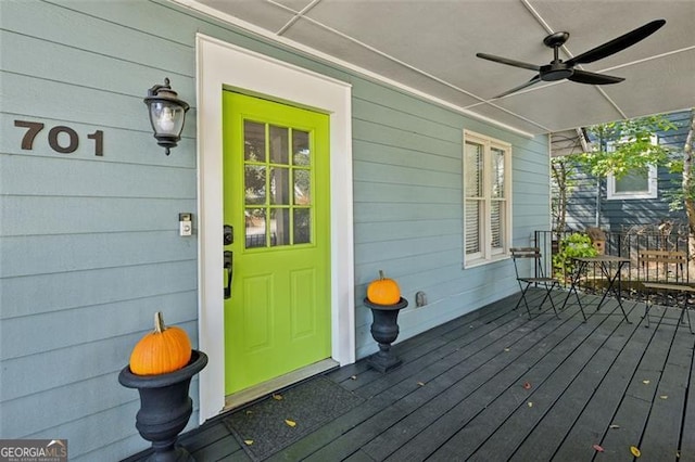 wooden terrace featuring ceiling fan