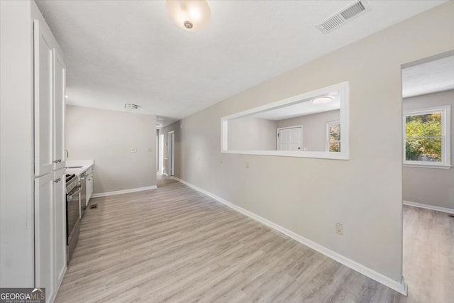 hallway with light wood-type flooring