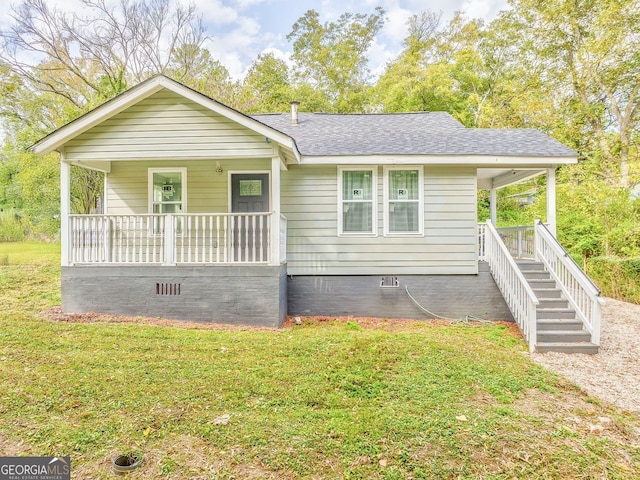 single story home with a porch and a front yard