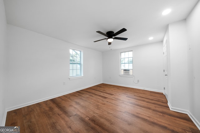 spare room featuring dark hardwood / wood-style flooring and ceiling fan