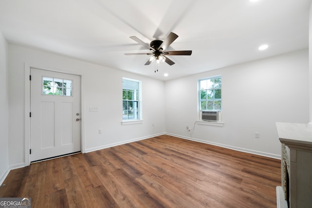 entryway featuring ceiling fan, a wealth of natural light, dark hardwood / wood-style floors, and cooling unit