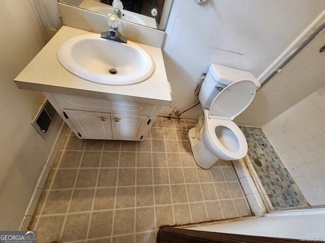 bathroom featuring vanity, toilet, and walk in shower