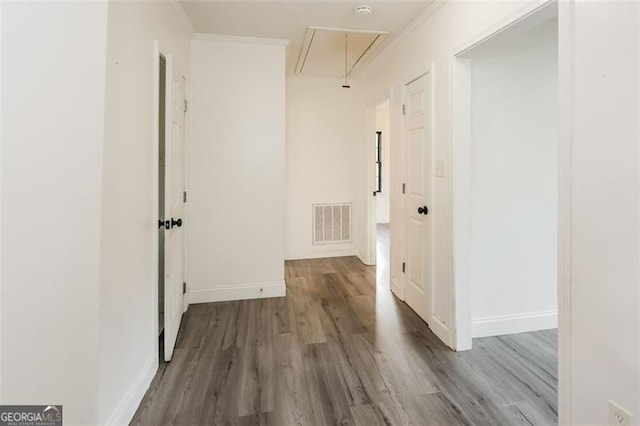 corridor featuring crown molding and hardwood / wood-style flooring