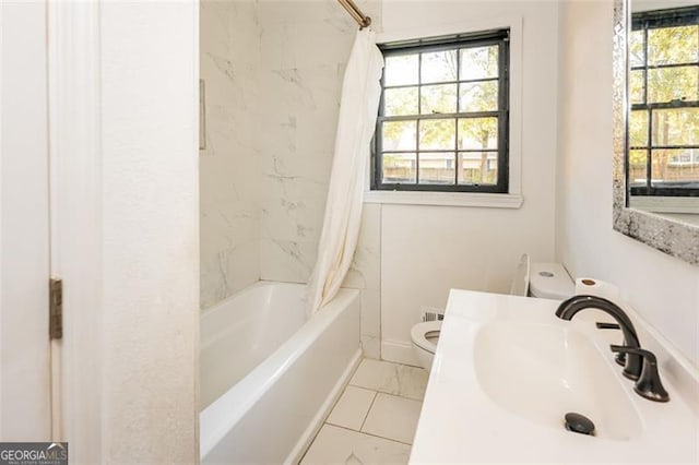 full bathroom with toilet, vanity, and shower / tub combo