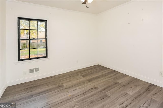 spare room featuring ceiling fan, hardwood / wood-style flooring, and ornamental molding