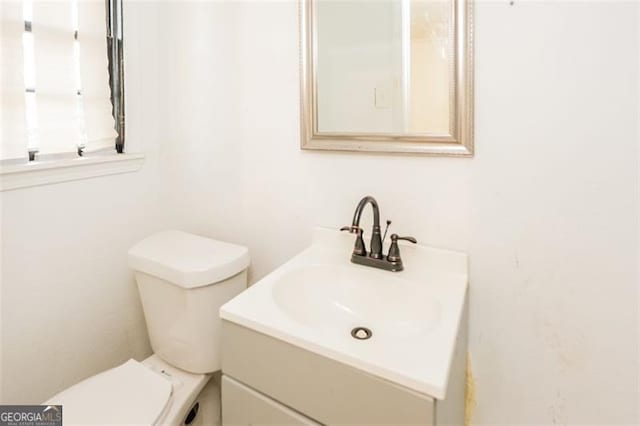 bathroom featuring vanity and toilet