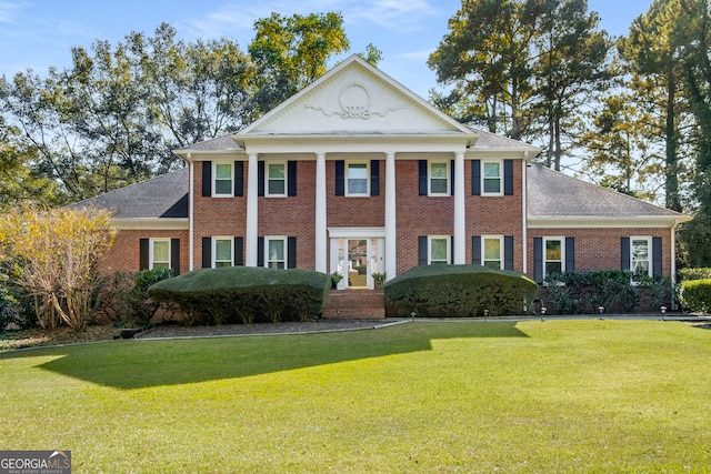 neoclassical home with a front lawn