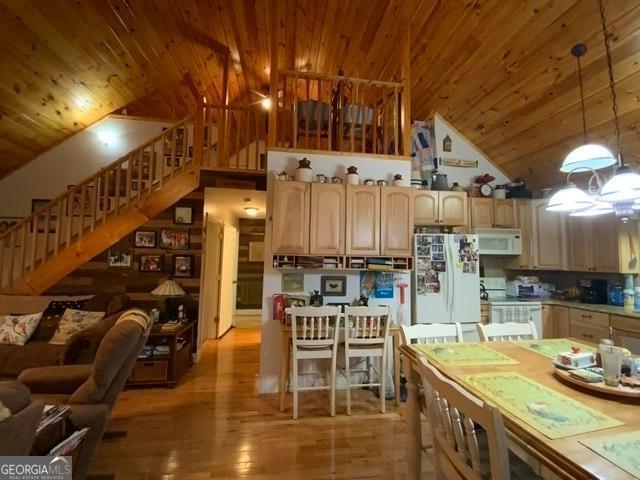 kitchen with light hardwood / wood-style flooring, hanging light fixtures, wooden ceiling, vaulted ceiling, and white appliances