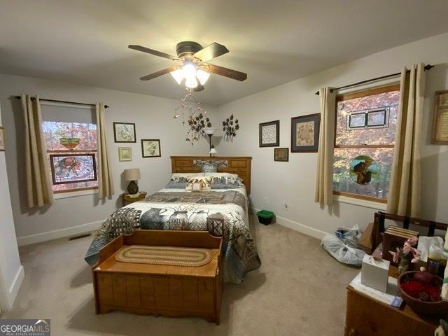 289 Cypress Cir, Ellijay, GA 30540 - carpeted bedroom with baseboards, ceiling fan, and visible vents