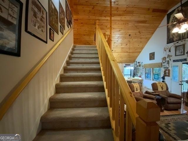 stairs with wood ceiling, high vaulted ceiling, and ceiling fan