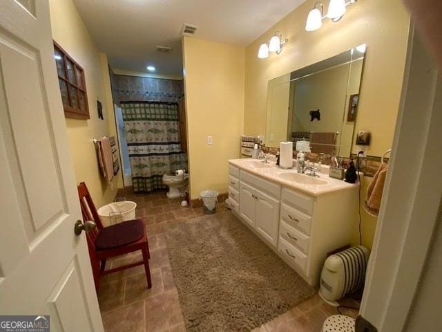 bathroom featuring vanity, a shower with shower curtain, and toilet