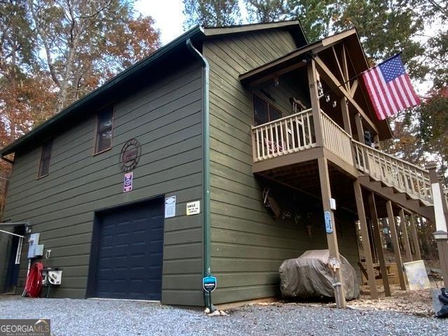 289 Cypress Cir, Ellijay, GA 30540 - view of property exterior featuring stairway, gravel driveway, a wooden deck, and a garage