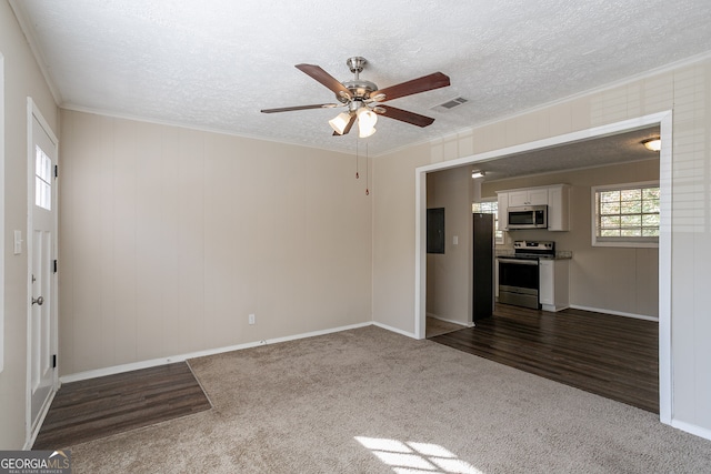 unfurnished living room with ornamental molding, dark hardwood / wood-style flooring, electric panel, a textured ceiling, and ceiling fan