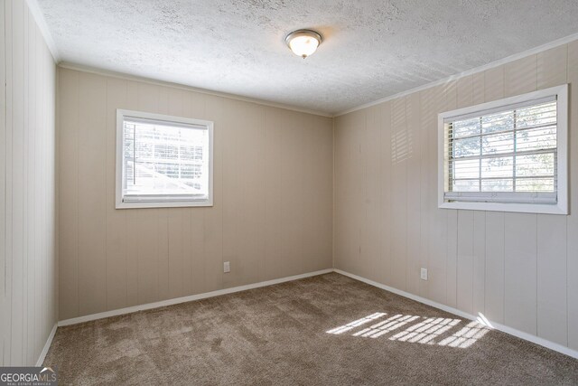 6230 Kensington Ct, Austell, GA 30106 - carpeted empty room featuring plenty of natural light, a textured ceiling, and crown molding