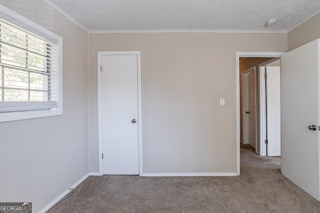 unfurnished bedroom featuring crown molding and light colored carpet