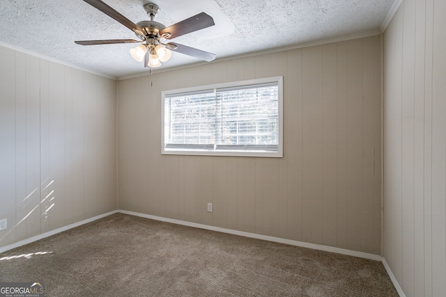 spare room with ceiling fan, carpet floors, and wooden walls