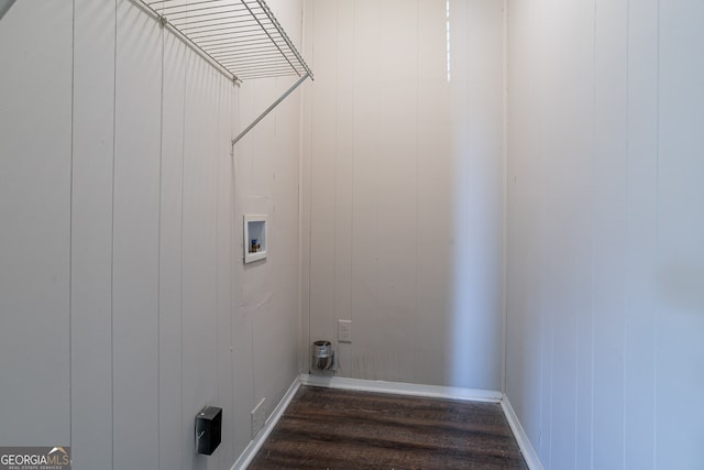 washroom featuring wood walls, dark hardwood / wood-style floors, and washer hookup