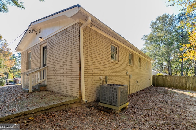 view of side of home with central AC