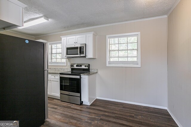 6230 Kensington Ct, Austell, GA 30106 - kitchen featuring appliances with stainless steel finishes, a textured ceiling, dark wood-style flooring, white cabinets, and light stone counters