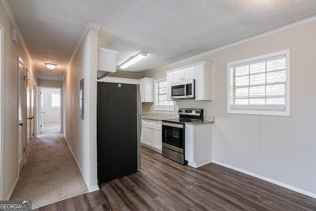 6230 Kensington Ct, Austell, GA 30106 - kitchen featuring stainless steel appliances, white cabinets, dark wood-style flooring, crown molding, and a textured ceiling