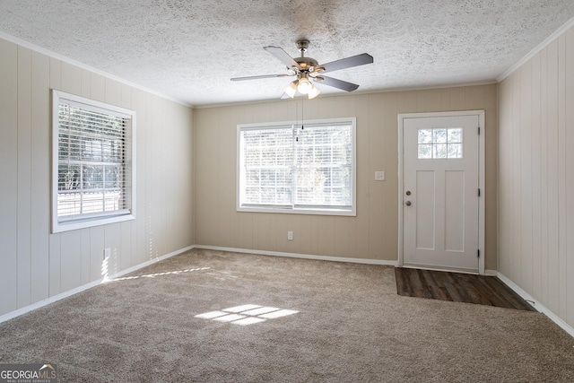 6230 Kensington Ct, Austell, GA 30106 - foyer entrance featuring carpet floors, crown molding, a ceiling fan, a textured ceiling, and baseboards