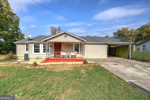 ranch-style house featuring a front yard, central AC unit, and a carport