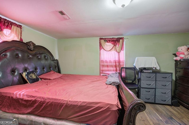 bedroom with hardwood / wood-style flooring