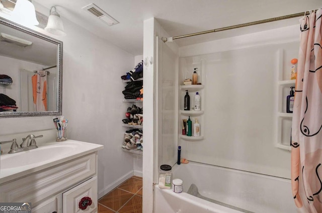 bathroom with vanity, shower / bath combo, and tile patterned floors