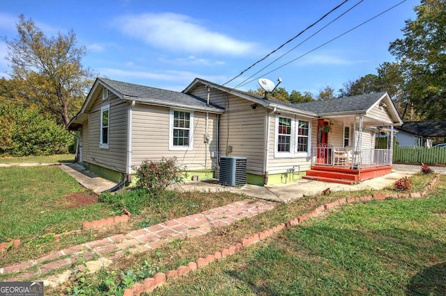 view of front of home with a front yard and central AC unit