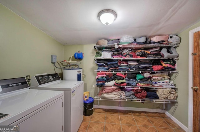 laundry area with electric water heater and washer and clothes dryer