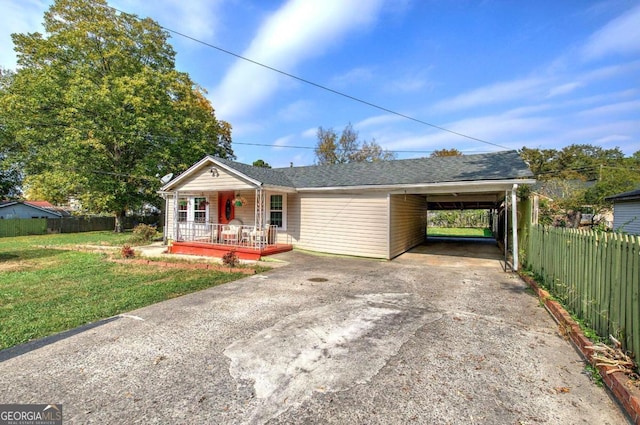 ranch-style home featuring a carport, a front lawn, and a porch