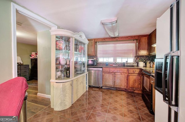 kitchen with appliances with stainless steel finishes and decorative backsplash