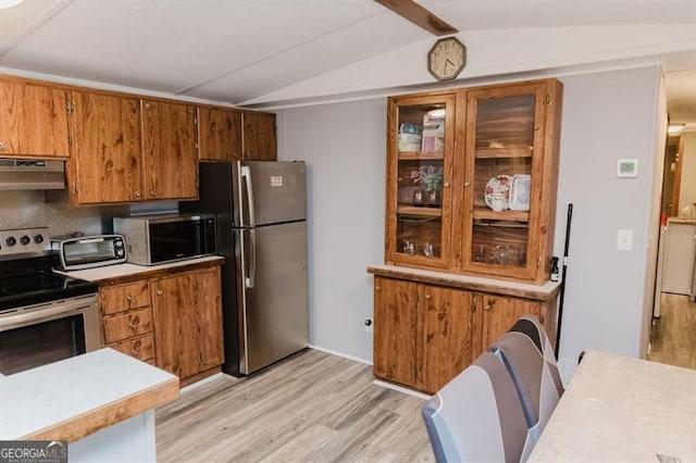 kitchen featuring appliances with stainless steel finishes, lofted ceiling with beams, light hardwood / wood-style floors, and range hood