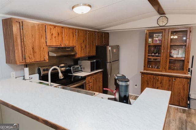 kitchen featuring sink, vaulted ceiling with beams, kitchen peninsula, stainless steel appliances, and light hardwood / wood-style flooring