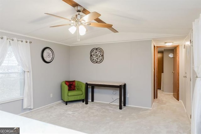 sitting room with lofted ceiling, crown molding, light carpet, and ceiling fan