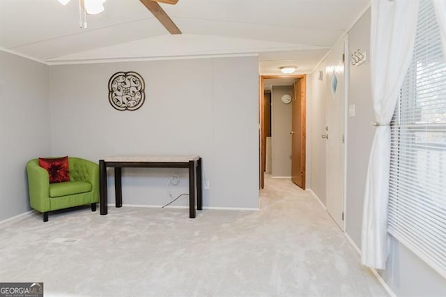 living area featuring lofted ceiling with beams, carpet flooring, and ceiling fan