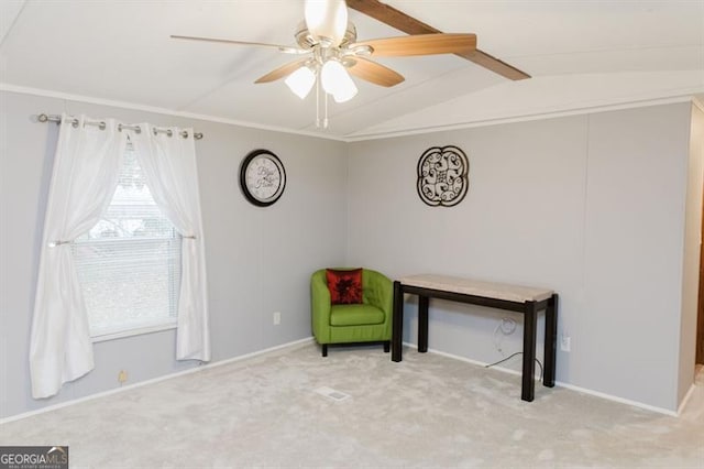 unfurnished room with vaulted ceiling with beams, light colored carpet, and ceiling fan