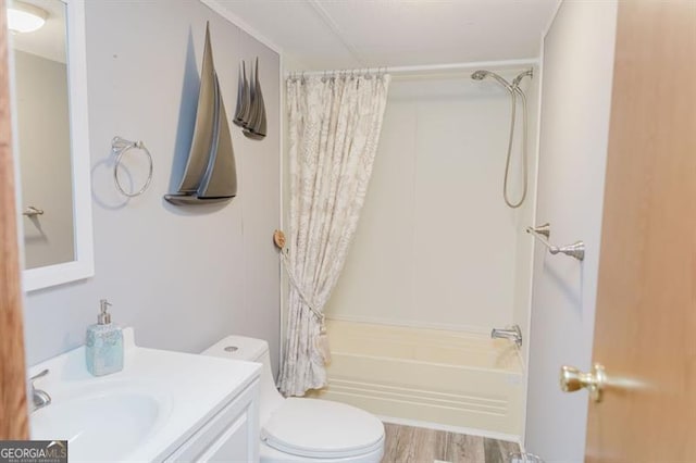 full bathroom with toilet, vanity, wood-type flooring, and shower / tub combo