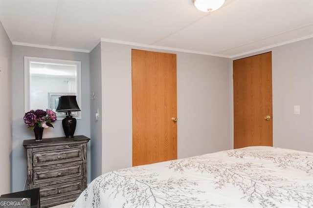 bedroom featuring ornamental molding and a closet